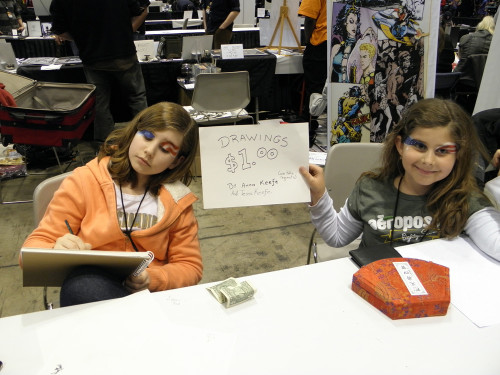 My daughters Tessa and Anna commandeering the $400 table of someone who left early.